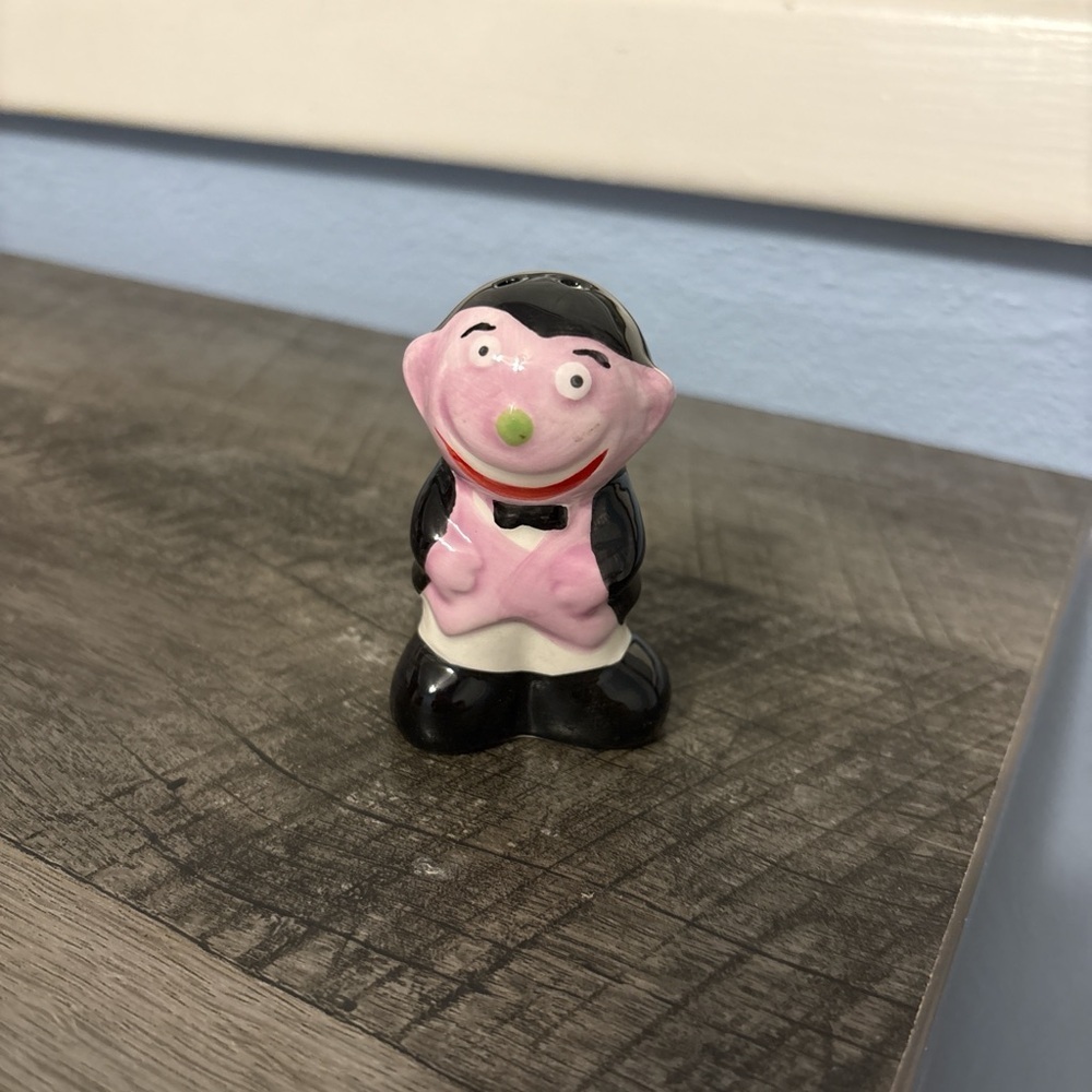 Gothic salt shakers with a spooky purple and black Dracula figure,